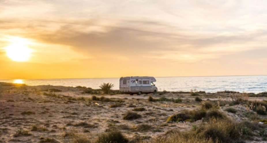 The Laurent family's caravan is seen parked on the Tunisian island of Djerba. The family rented a house on the island a few days before Tunisia imposed strict movement restrictions in a bid to slow the spread of the novel coronavirus.  By - HERE WE ARE WORLDAFP
