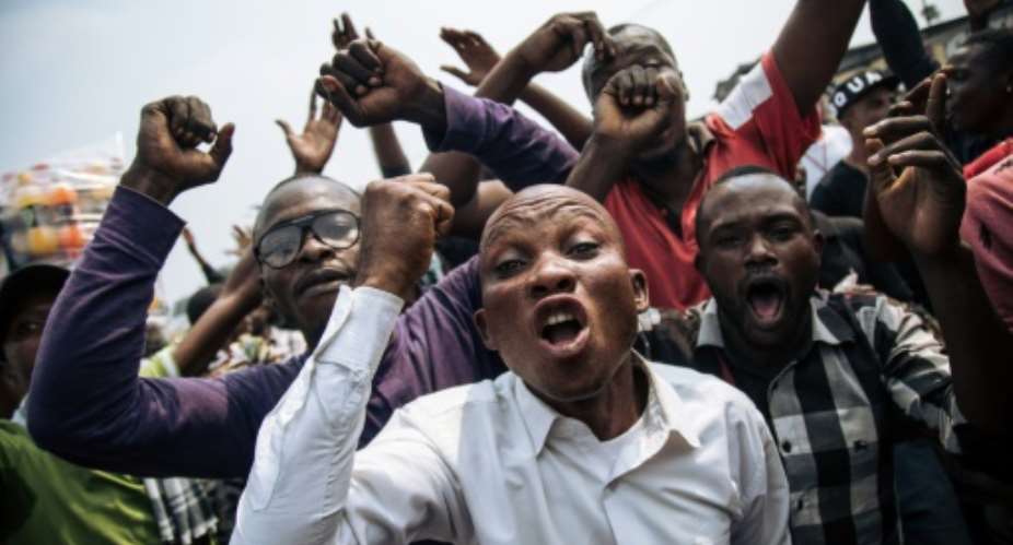 The march was called to protest the DR Congo constitutional court's invalidation of the election of about 20 opposition lawmakers.  By ALEXIS HUGUET AFP