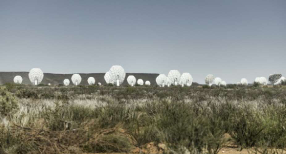 The MeerKAT radio telescope is made up of 64 giant white dishes that stand in a semi-desert region in South Africa.  By MARCO LONGARI (AFP)