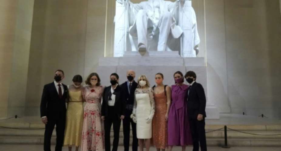 The new first family of the United States pose in front of a statue of Abraham Lincoln while wearing face masks following Joe Biden's inauguration.  By JOSHUA ROBERTS POOLAFP