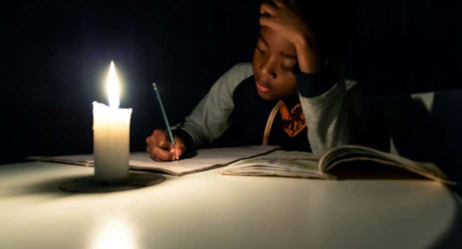 The next time there's electricity will be past his bedtime.  By Jekesai NJIKIZANA AFP