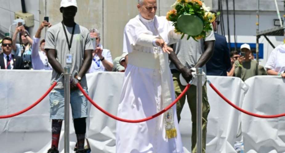 The pope cast a floral wreath in tribute to the migrants who have died trying to reach the Canary Islands.  By Stefano RELLANDINI (AFP)