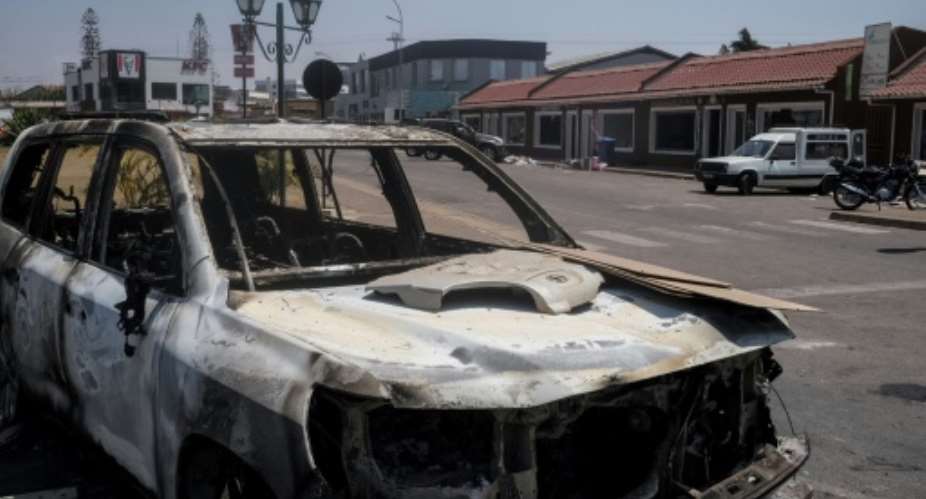 The protest left burnt-out cars strewn across the streets of Madagascars capital.  By RIJASOLO (AFP)