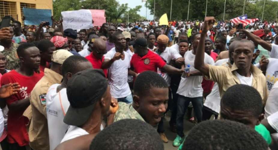 The protest was led by lawmaker Yeke Korlubah centre, in white shirt, one of Weah's most vociferous critics.  By CARIELLE DOE AFP