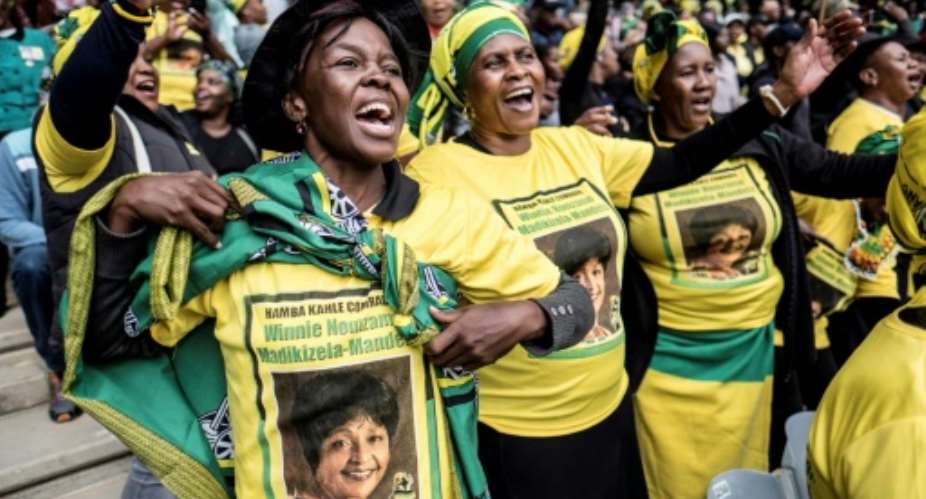 The ruling ANC's signature green, yellow and black adorned mourners' shirts and flags and women's head-wraps.  By MARCO LONGARI AFP