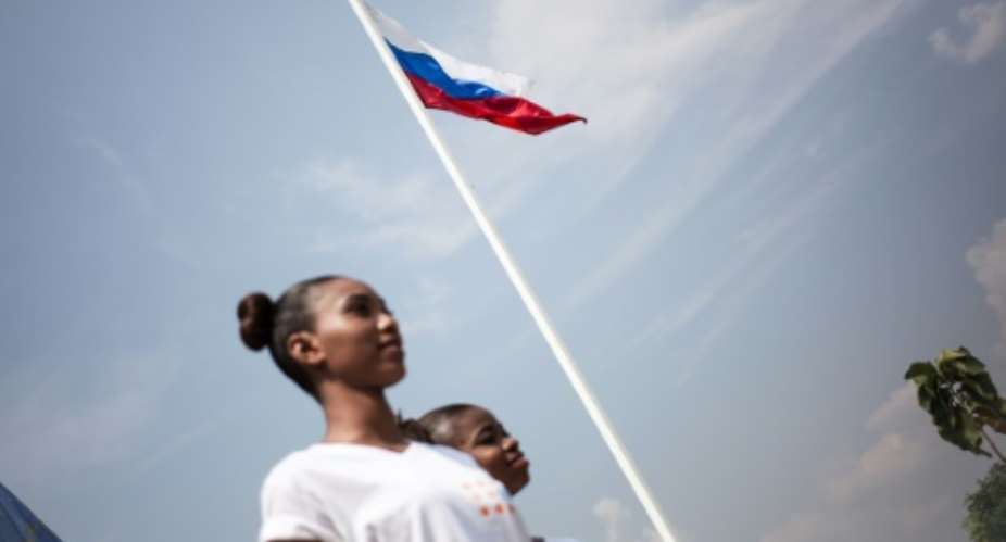 The Russian flag flies over a stadium in Bangui: Russia was fiercely critical of the French approach to negotiating renewal of the UN peacekeeping mission in the Central African Republic.  By FLORENT VERGNES AFPFile