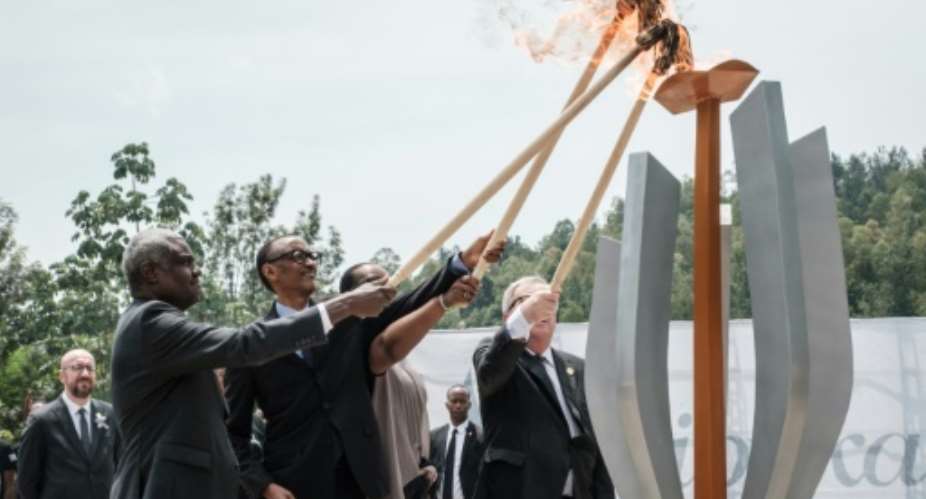 The Rwandan president, centre, lit the remembrance flame along with African Union chief Moussa Faki and Rwandan First Lady Jeannette Kagame.  By Yasuyoshi CHIBA AFP