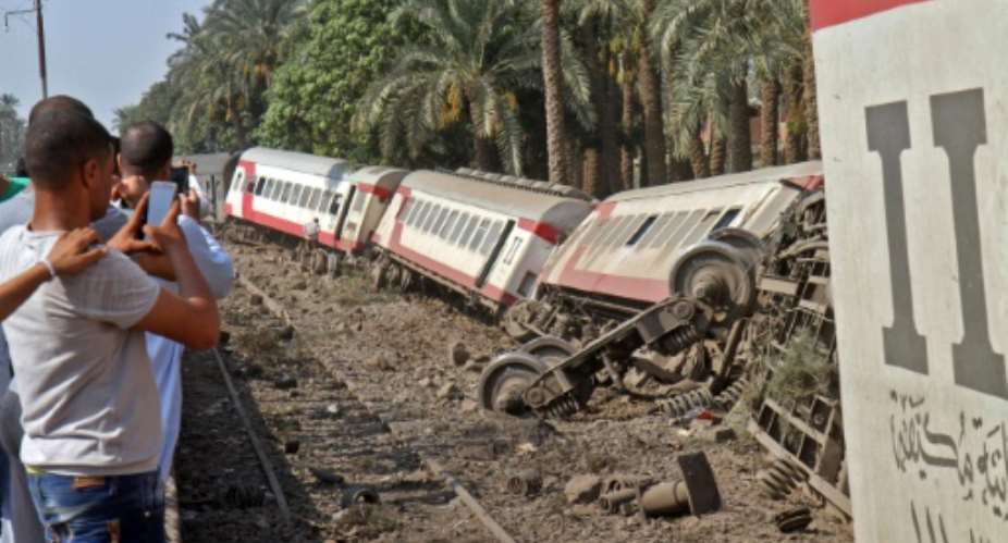 The scene of a train derailment near Badrashin, 20 kilometres 12 miles south of Egypt's capital Cairo on July 13, 2018.  By STRINGER AFP