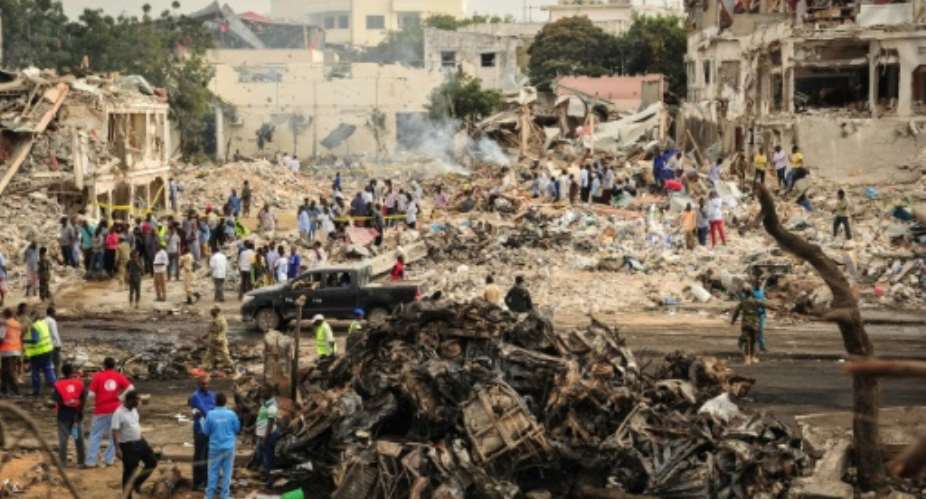 The scene of the explosion of a truck bomb in the centre of Mogadishu on October 15, 2017.  By Mohamed ABDIWAHAB AFP