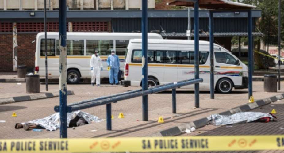 The shooting of four people at a Johannesburg taxi rank is linked to long-running rivalries in South Africas transport industry.  By EMMANUEL CROSET (AFP)