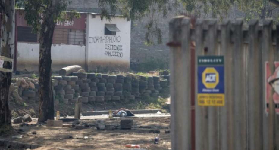 The shooting that claimed 12 lives was in an impoverished area of metal shacks near where illegal miners were living.  By EMMANUEL CROSET (AFP)