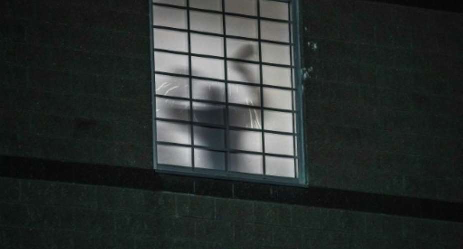 The silhouette of a person inside an ICE detention centre in Newark, New Jersey.  By Ryan MURPHY (AFP)