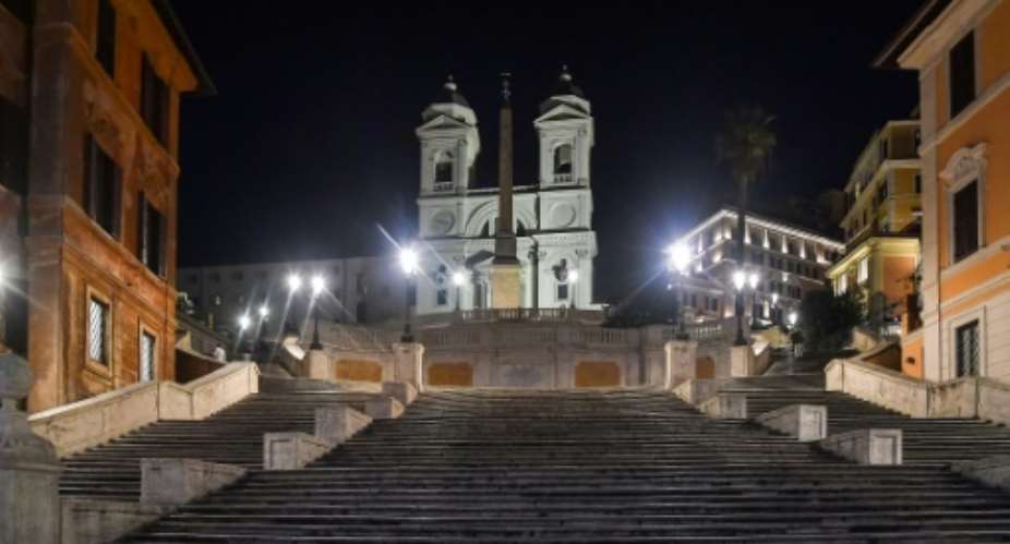 The Spanish Steps in Rome are deserted after sunset, after Italy imposed unprecedented restrictions to check the spread of the new coronavirus and the death toll soared to 631 people.  By Tiziana FABI AFP