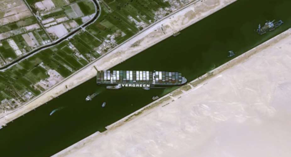 The Taiwan-run MV Ever Given container ship is lodged sideways and impeding all traffic across the Egypt's Suez Canal.  By - Cnes2021, Distribution Airbus DSAFP