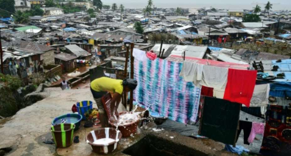 The tin-roofed shacks in Freetown's slums are badly exposed to climate extremes, especially heat.  By CARL DE SOUZA AFP