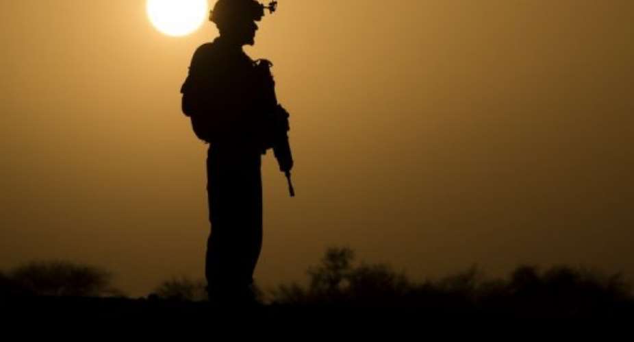 A French soldier stands at sunset on April 7, 2013, some 105 kilometers north of Gao.  By Joel Saget AFPFile
