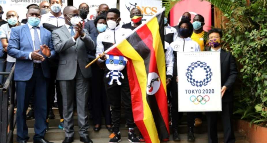The Uganda Olympic boxing team, with officials including Mizumoto Horii, deputy head of mission for Japan in Uganda, flag off the squad in Kampala before flying to Tokyo on June 17. Now a member of the entourage has tested positive upon landing.  By Badru Katumba AFP