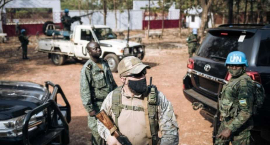 The United Nations Security Council has asked all forces in the Central African Republic to guarantee the safety of UN peacekeepers -- one is seen at right in 2020 in the capital Bangui.  By ALEXIS HUGUET AFPFile