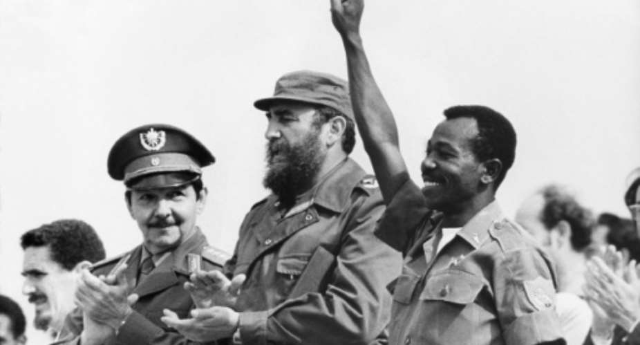 Then Ethiopian President Lieutenant Colonel Mengistu Haile Mariam R makes V sign alongside Fidel Castro C and Raul Castro L during an official visit to Havana, Cuba, on April 15, 1975.  By  PRENSA LATINAAFPFile