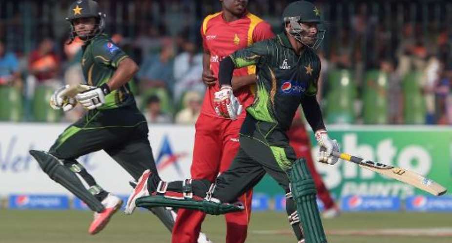 Pakistan's captain Azhar Ali L and Mohammad Hafeez R during the third and final one day international against Zimbabwe on May 31, 2015.  By Aamir Qureshi AFP