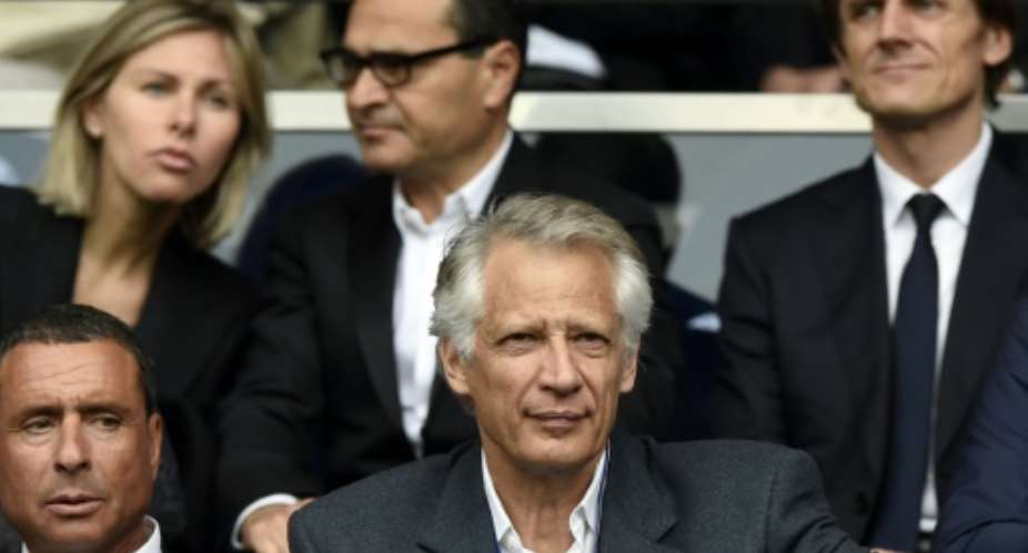 This file photo taken on April 23, 2014 shows France's former prime minister Dominique de Villepin C and businessman Alexandre Djouhri L at a football match..  By FRANCK FIFE AFPFile
