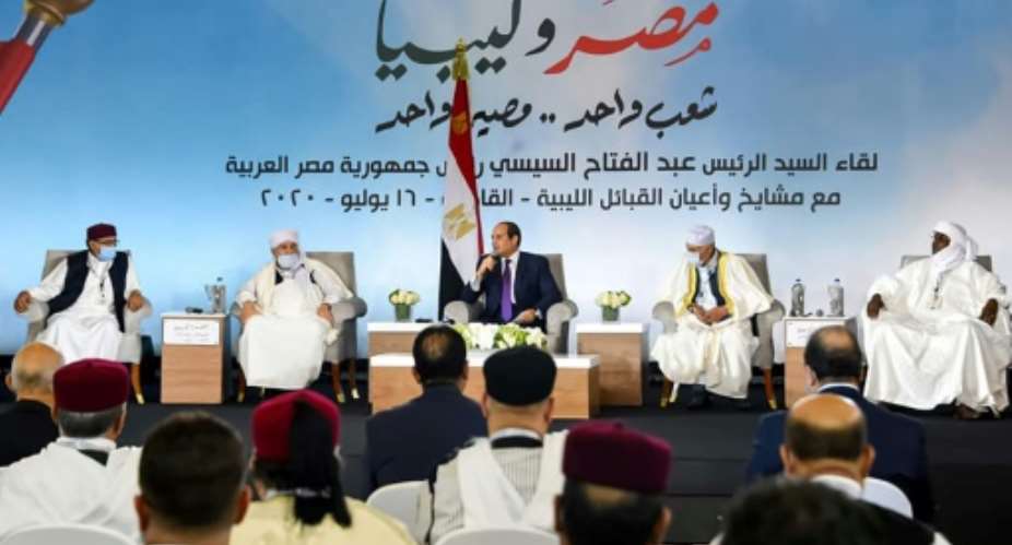 This photo posted on the official Facebook page of Egypt's presidential spokesman on July 16, 2020 shows President Abdel Fattah al-Sisi C meeting with mask-clad Libyan tribal leaders in the capital Cairo.  By - Egyptian PresidencyAFP
