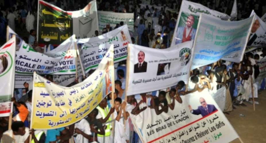 This photo taken on July 20, 2017 shows supporters of Mauritanian President gathering and holding banners during a rally ahead of the constitutional referendum on scrapping the senate and changing the national flag, in Nouakchott.  By STR AFPFile