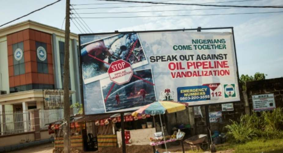 This photo taken on June 10, 2016 shows an advertising board concerning the oil pipeline vandalization in the City of Warri in Delta State.  By Stefan Heunis AFPFile