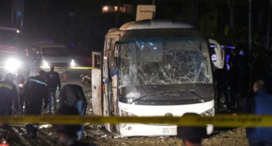 This picture taken on December 28, 2018 shows the scene of an attack on a tourist bus near the Giza Pyramids outside Cairo.  By MOHAMED EL-SHAHED AFP