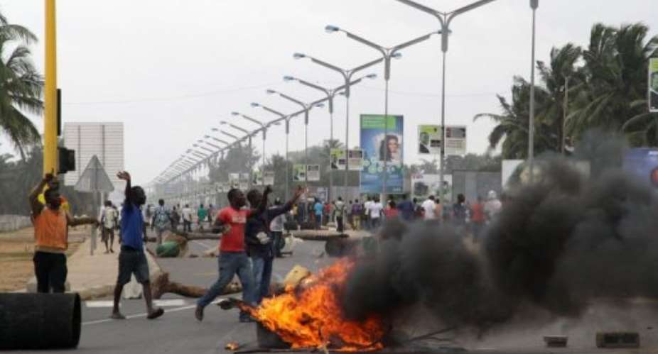 Opposition supporters burn tyres and demonstrate in Lome on August 22.  By Emile Kouton AFPFile