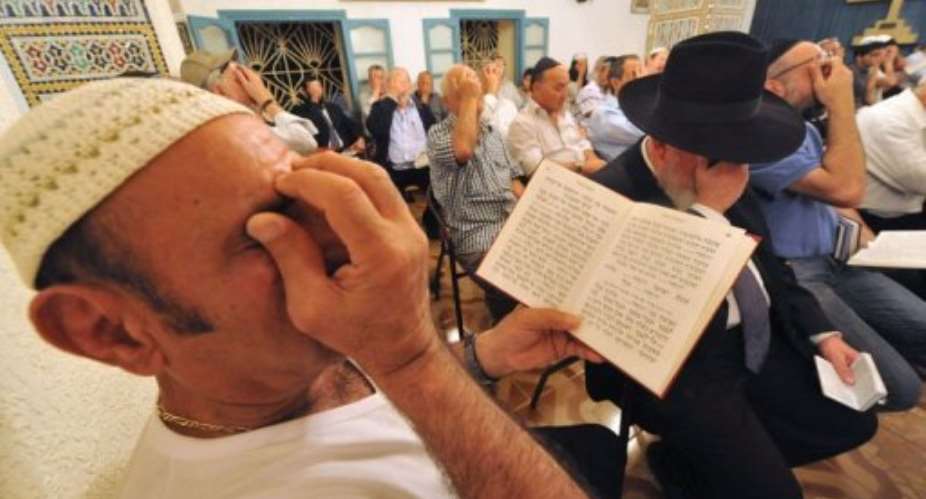 Jewish men pray  at the Amram ben Diwan synagogue during a Jewish pilgrimage.  By Abdelhak Senna AFPFile
