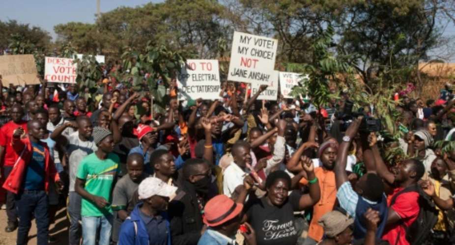 Thousands of opposition parties supporters participate in a protest in Malawi's capital Lilongwe, to force Malawi Electoral Commission chairperson Jane Ansah to resign and to protest the alleged use of correction fluid in the marked ballots.  By AMOS GUMULIRA AFP