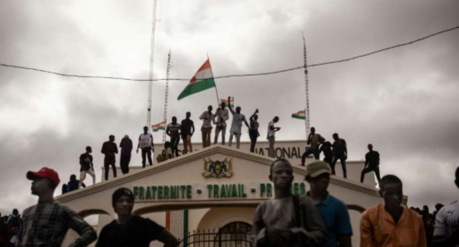 Thousands of people rallied to back the coup leaders on the anniversary of Niger's 1960 independence from France.  By - AFP