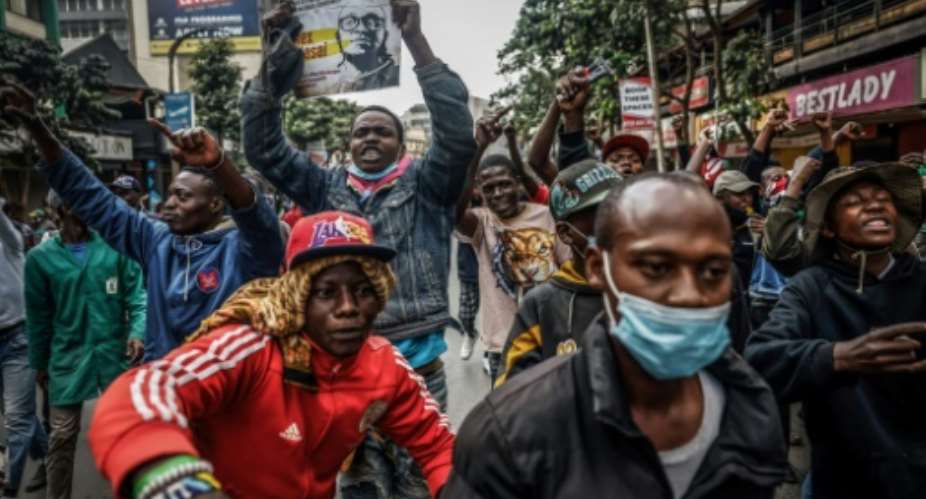 Thousands of protesters waved Kenyan flags and placards with pictures of demonstrators killed last year.  By Luis TATO (AFP)