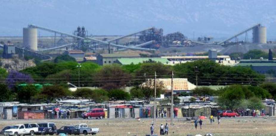 A picture taken on October 6, 2012 shows workers standing outside the Anglo American Platinum (Amplats) mine in Rustenburg.  By Alexander Joe (AFP/File)