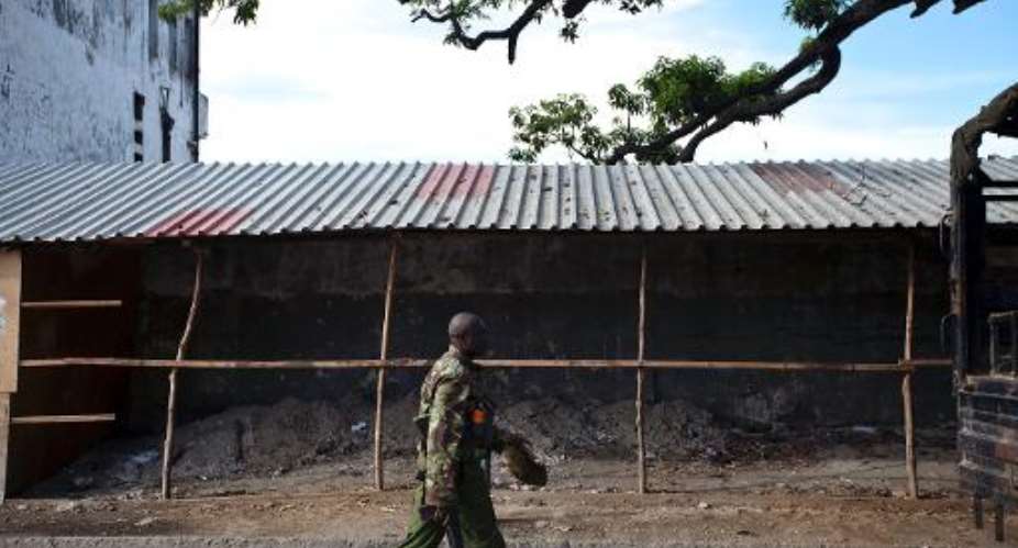A Kenyan police officer patrols in the Majengo area of Mombasa on April 5, 2014.  By Ivan Lieman (AFP/File)