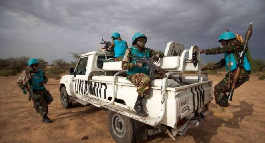 A handout picture taken on July 1, 2014 and released by the United Nations-African Union Mission in Darfur on July 2, 2014 shows UNAMID troops deployed in Khor Abeche, South Darfur.  By Albert Gonzalez Farran UNAMIDAFPFile