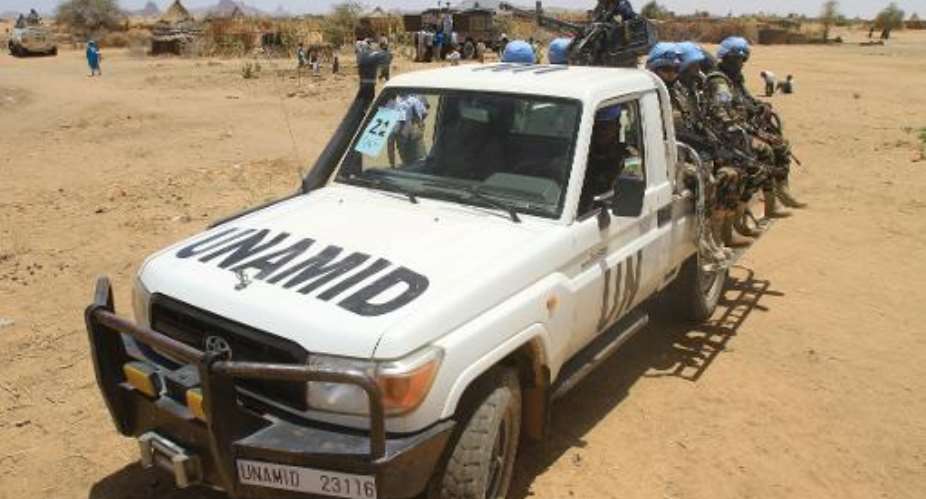 Peace-keepers with the United Nations-African Union Mission in Darfur (UNAMID) patrol on June 18, 2013.  By Ashraf Shazly (AFP/File)