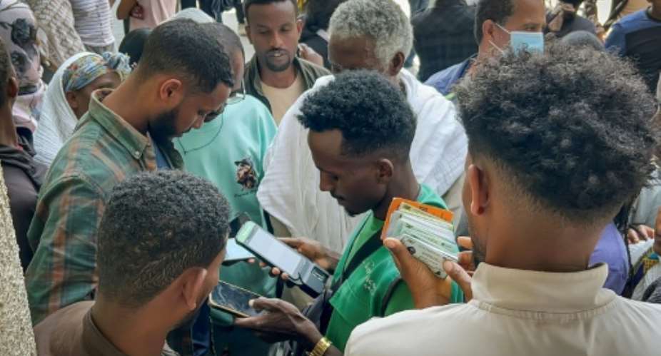 Tigrayan locals flocked to buy new sim cards amid a telecoms shutdown.  By - (AFP)
