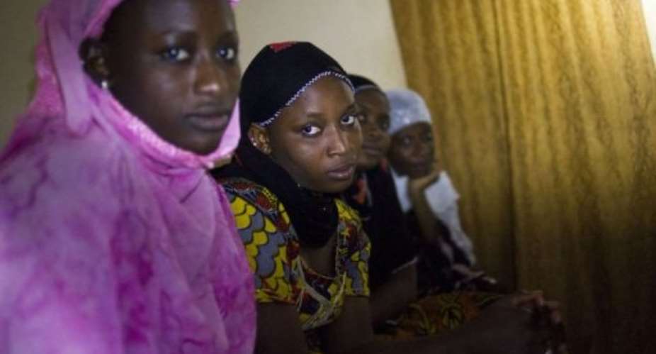Malian women pose during a dinner in their home, on January 31, 2013, in Timbuktu.  By Fred Dufour AFPFile