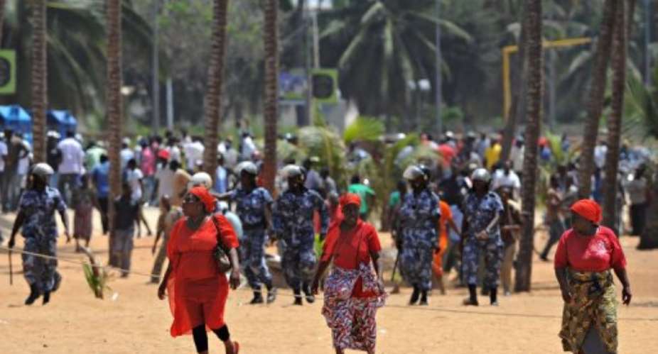 Opposition supporters run across the beach in Lome on March 14, 2013.  By Daniel Hayduk (AFP/File)