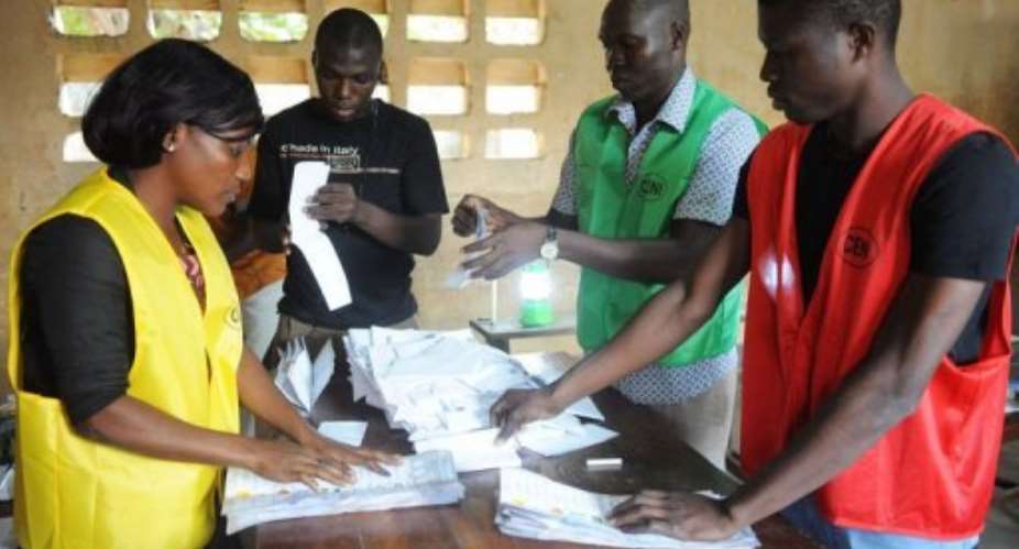 Members of Togo's Independent National Electoral Commission CENI sort votes on July 25, 2013 in Lome.  By Pius Utomi Ekpei AFP