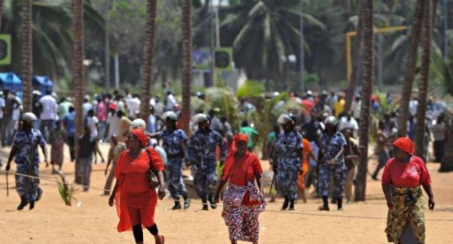 Opposition supporters run as police move demonstrators who attempted a sit-in in Lome on March 14, 2013.  By Daniel Hayduk (AFP/File)