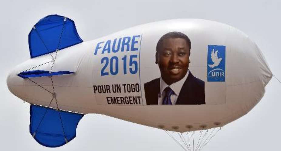 A campaign blimp with the portrait of President Faure Gnassingbe of Togo flies over Lome, on April 23, 2015.  By Issouf Sanogo AFPFile