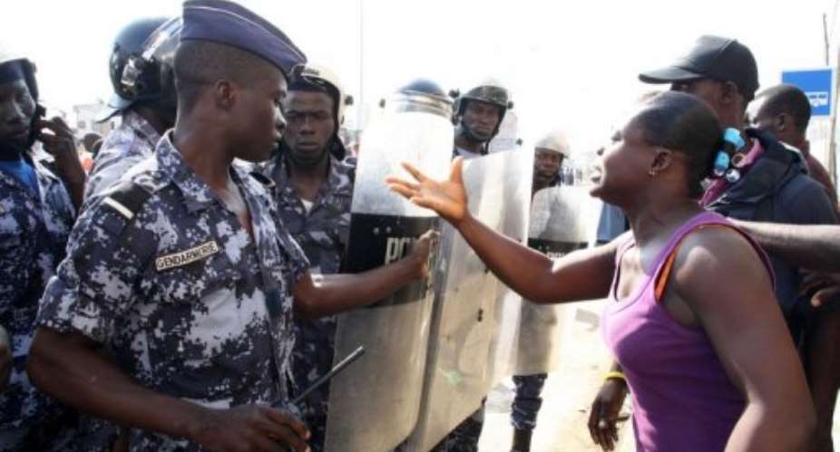 A woman talks to police officers as they patrol near a meeting of''Let's Save the Togo''.  By Emile Kouton AFPFile