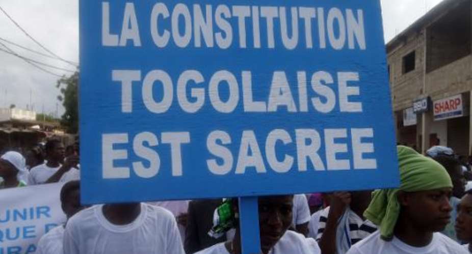 A demonstrator in Lome last week holds a banner reading The Togolese Constitution is sacred.  By Emile Kouton AFPFile