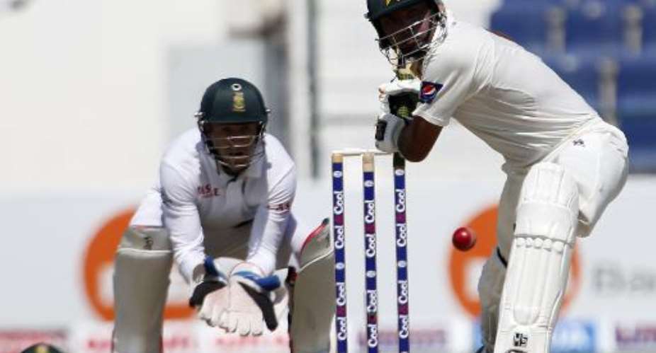 Pakistans opener Khurram Manzoor (right) bats as South African wicketkeeper AB de Villiers looks on during the second day of their first Test at the Sheikh Zayed Cricket Stadium in Abu Dhabi on October 15, 2013.  By Karim Sahib (AFP)