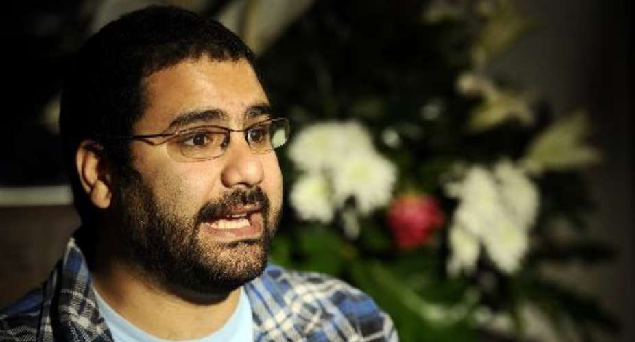 Egyptian blogger and activist Alaa Abdel Fattah speaks during a TV interview at his house in Cairo on December 26, 2011.  By Filippo Monteforte AFPFile