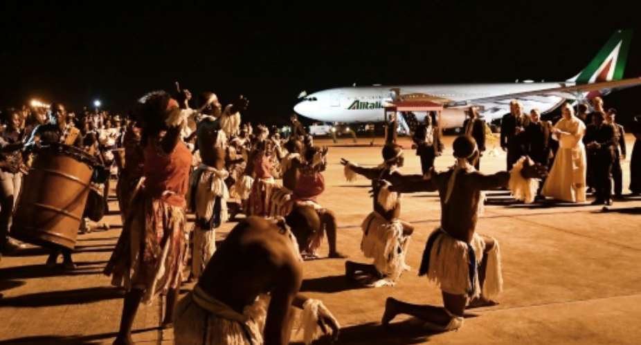 Touching down in Mozambique, Francis was welcomed by a military band and a display of traditional dance.  By Tiziana FABI AFP