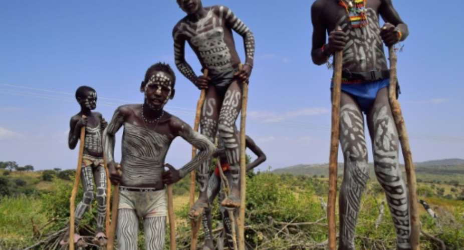 Traditionally mixed from clay, chalk, ash and cattle dung, the white or grey body paint is widely thought to help individuals moderate body heat amid soaring bush and savanna temperatures.  By CARL DE SOUZA AFPFile
